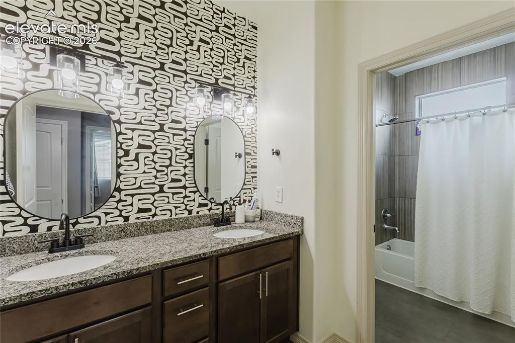 Image 26 of 46: Dual vanity with granite countertop, undermount sinks, matte black fixtures