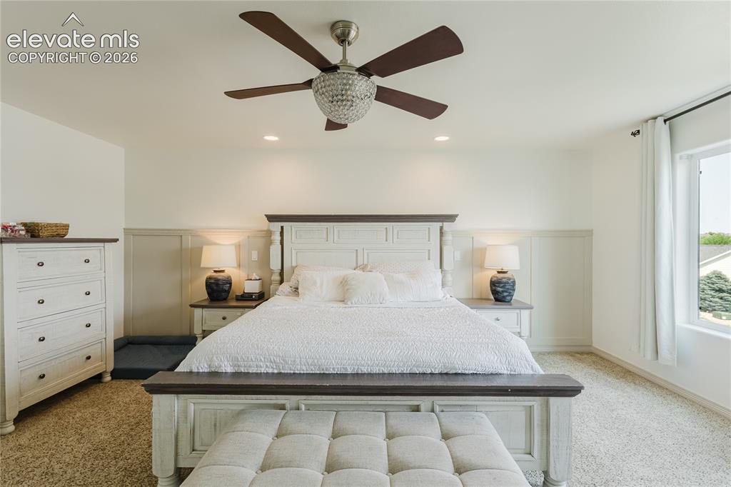 Image 27 of 46: Bright interior room featuring a decorative crystal ceiling fan, recessed l