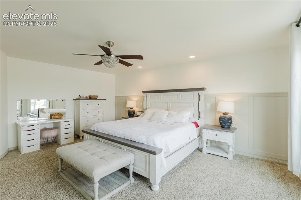 Image 28 of 46: Spacious room featuring neutral carpeting and a decorative ceiling fan