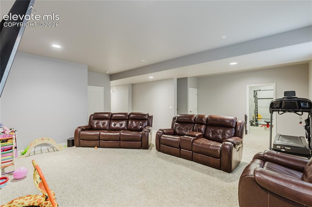 Image 36 of 46: Carpeted lower level featuring recessed lighting, a neutral color palette,