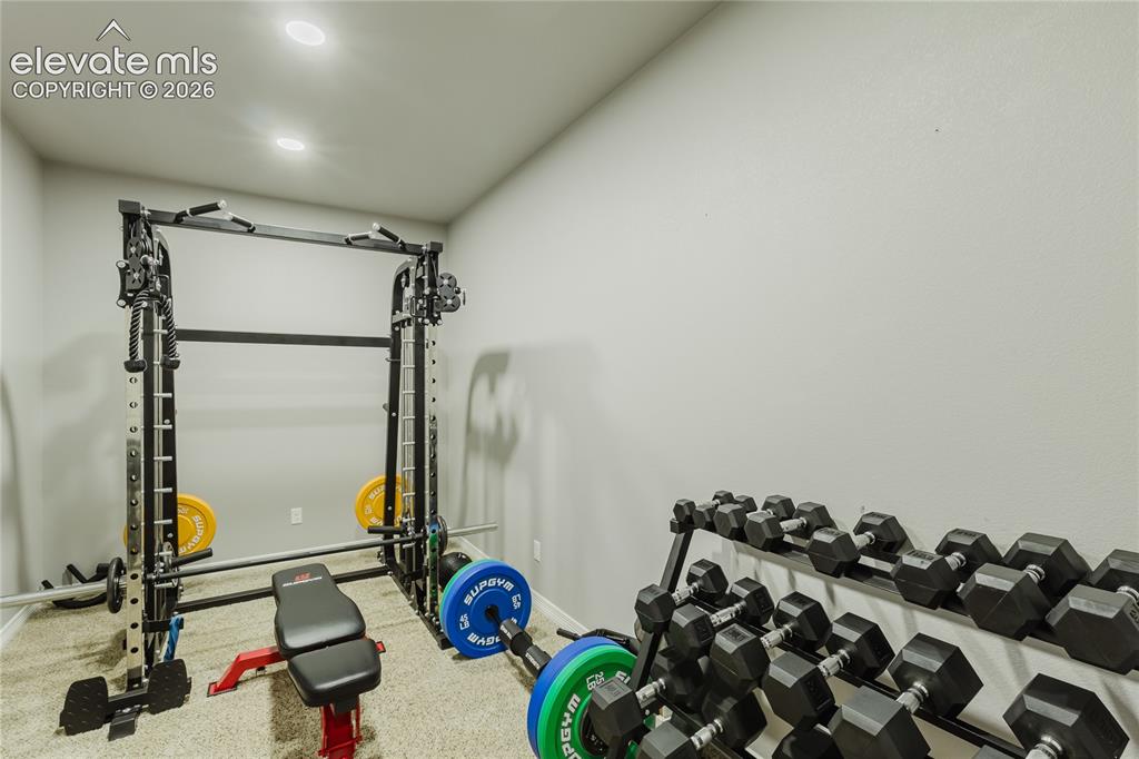 Image 37 of 46: Dedicated fitness area featuring recessed lighting, light gray walls, and t
