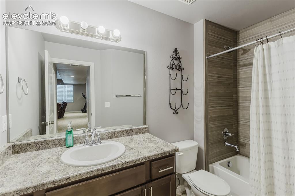 Image 39 of 46: Bathroom featuring a single vanity with a laminate countertop, undermount s
