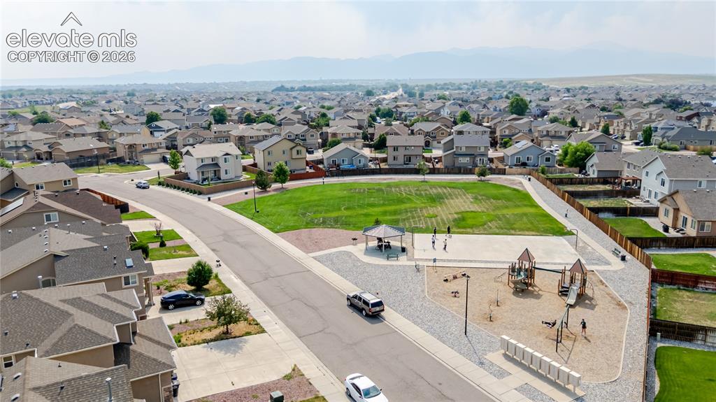 Image 46 of 46: Neighborhood green space with a playground, covered picnic area, and walkin
