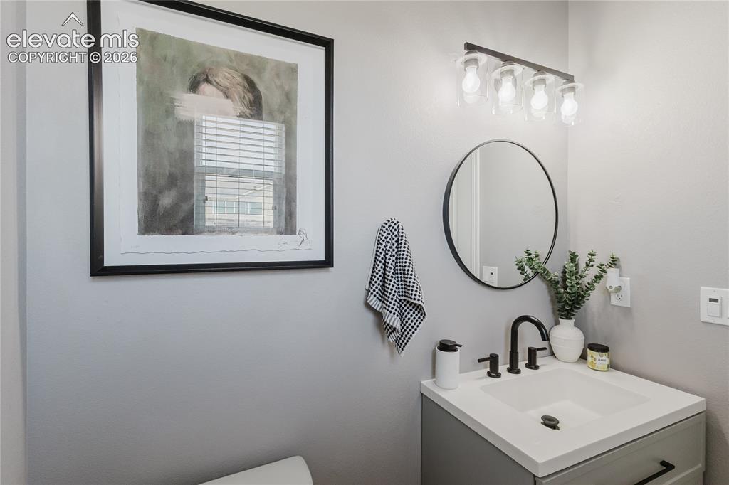 Image 6 of 46: Vanity featuring a rectangular undermount sink, light countertop, and matte