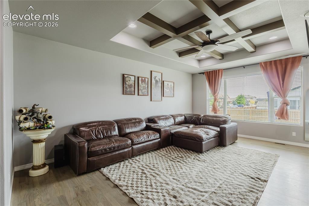 Image 9 of 46: Living space featuring a coffered ceiling with recessed lighting and a ceil