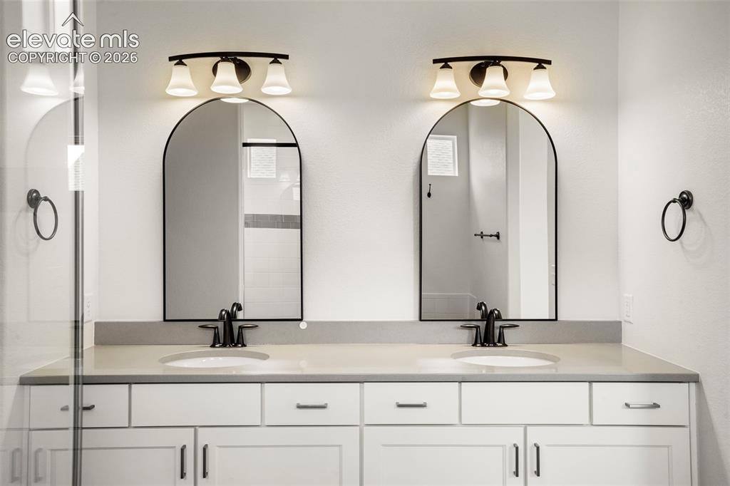 Image 15 of 37: Dual arched mirrors above separate undermount sinks