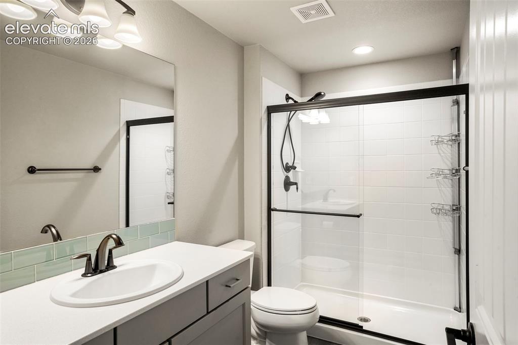 Image 25 of 37: Full bathroom in basement featuring a single vanity with a white countertop