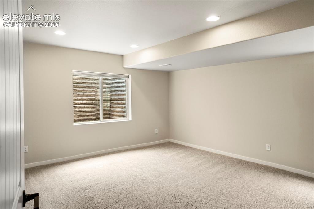 Image 26 of 37: Second primary bedroom in basement. Non-conforming due to no closet. 