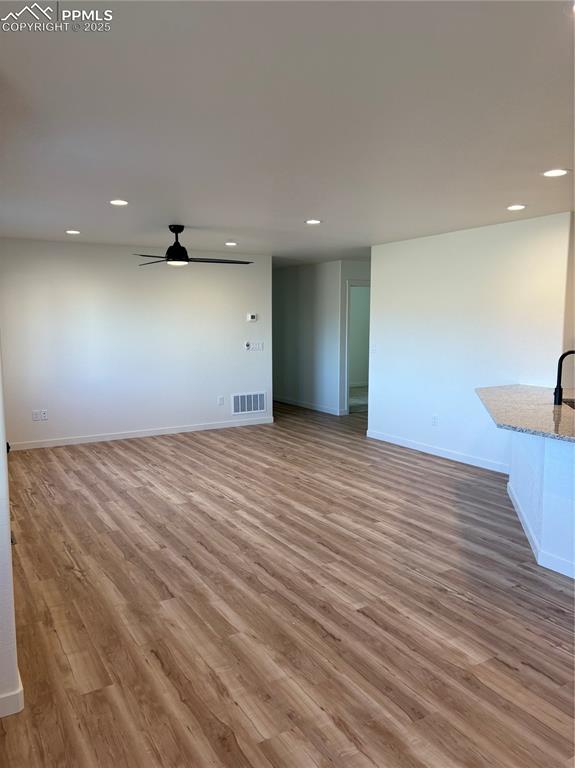 Image 11 of 22: Unfurnished living room featuring recessed lighting, light wood-type floori