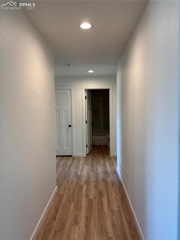 Image 12 of 22: Hall featuring light wood-style flooring, recessed lighting, and a textured