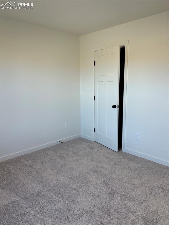 Image 13 of 22: Carpeted empty room featuring baseboards