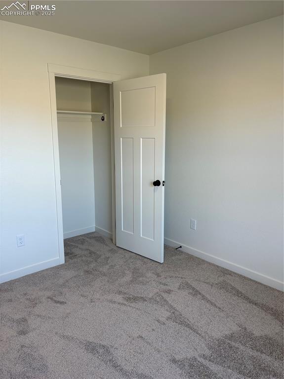 Image 17 of 22: Unfurnished bedroom featuring light carpet and a closet