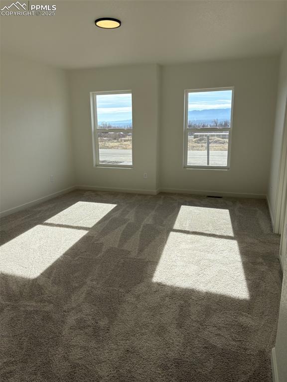 Image 18 of 22: Unfurnished room with carpet flooring