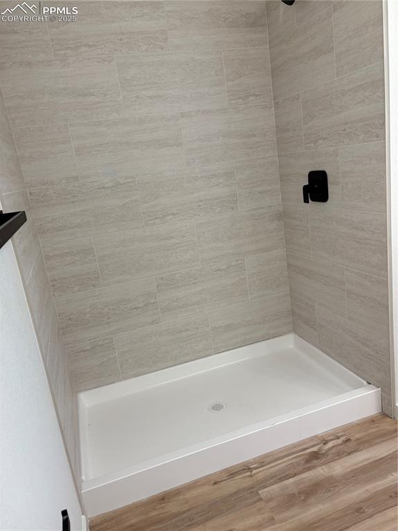 Image 20 of 22: Bathroom featuring wood finished floors and a stall shower