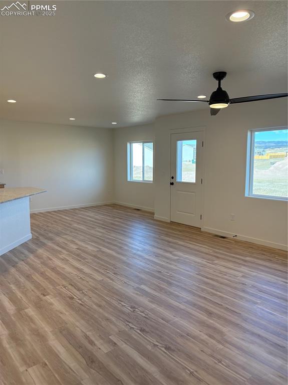 Image 7 of 22: Unfurnished living room featuring recessed lighting, light wood-style floor