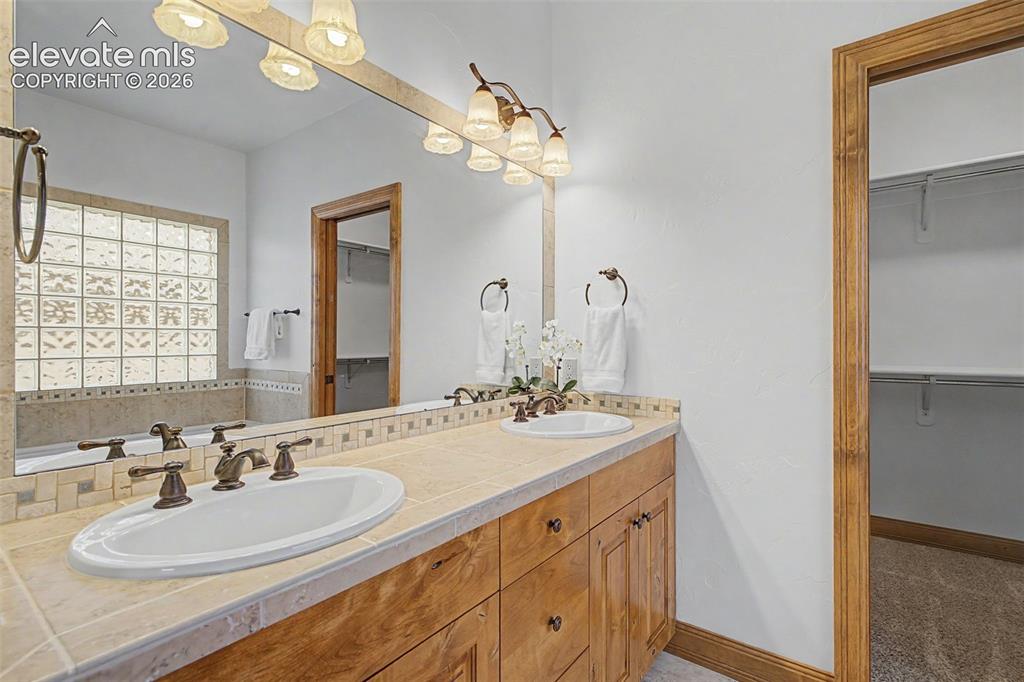Image 31 of 42: Dual vanity and large walk in closet