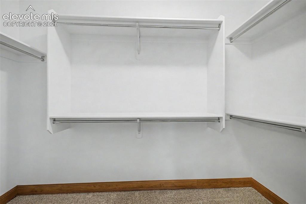 Image 33 of 42: HUGE primary walk-in closet