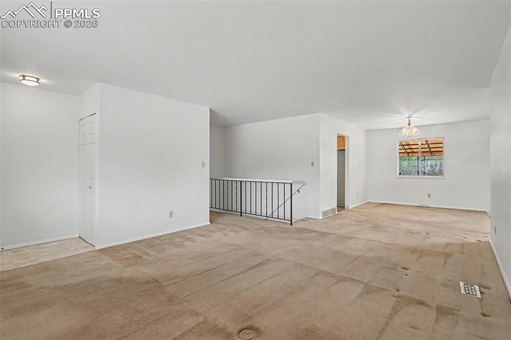 Image 2 of 44: Living room toward hallway & dining area