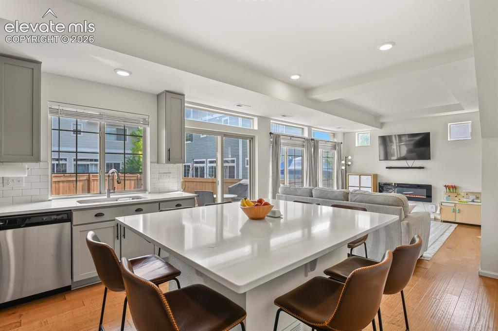 Image 11 of 31: Bright open-concept between the kitchen and living room area 