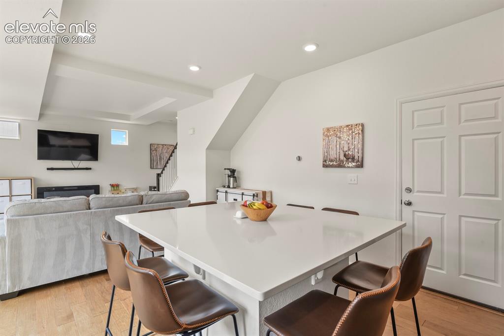 Image 12 of 31: Spacious interior featuring a large kitchen island with seating, recessed l