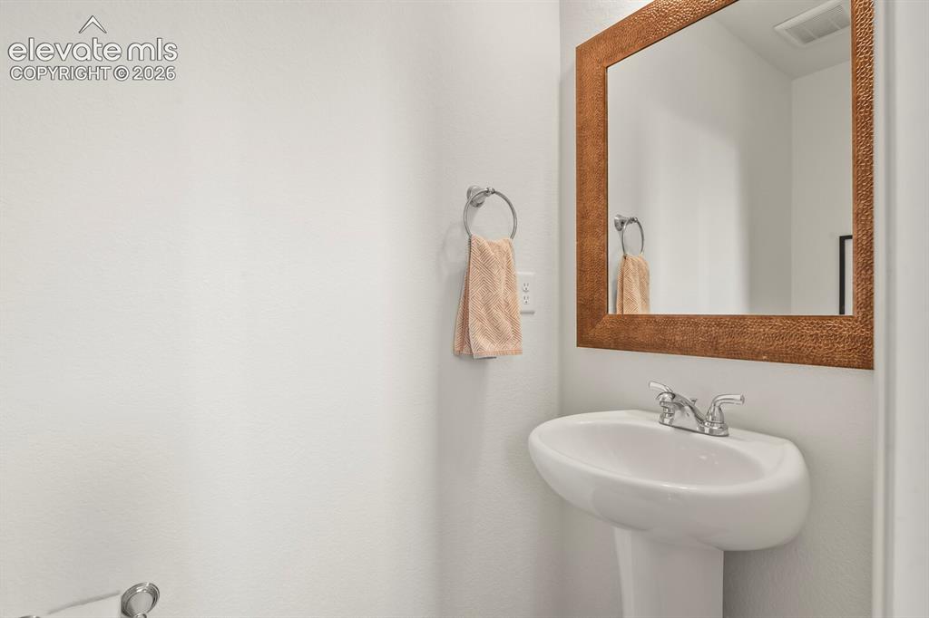 Image 13 of 31: Powder room located on main level and perfect for guests