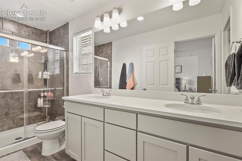 Image 17 of 31: Bathroom featuring a double vanity with two sinks, a large wall-mounted mir