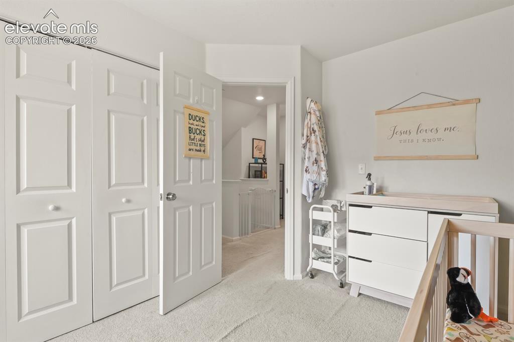 Image 19 of 31: Bedroom #2. Bright and featuring a six-panel interior door and bifold close