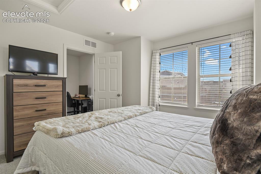 Image 22 of 31: Bedroom #3 featuring multiple windows creating a nice bright space.