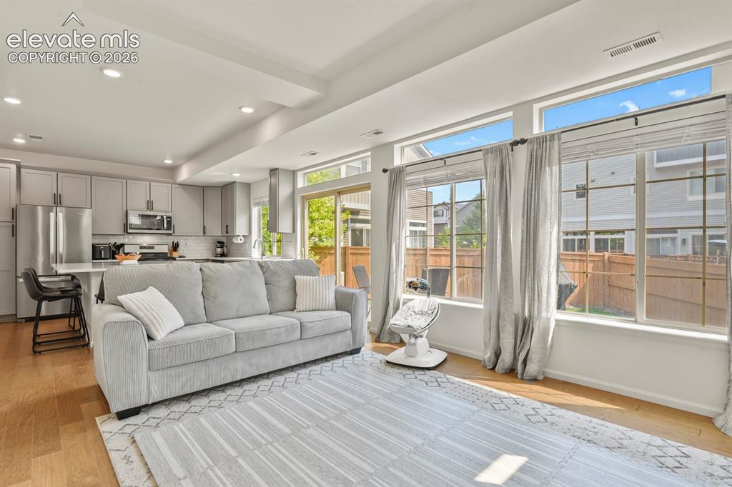 Image 5 of 31: Open-concept living space featuring wood flooring and recessed lighting