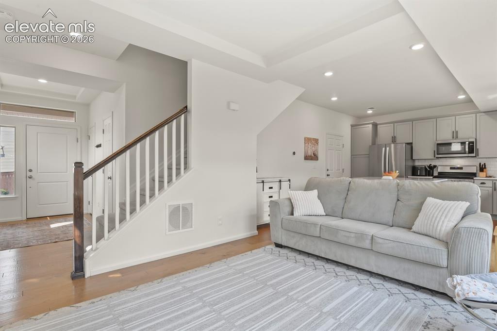 Image 6 of 31: Open-concept living area featuring wood flooring and recessed lighting