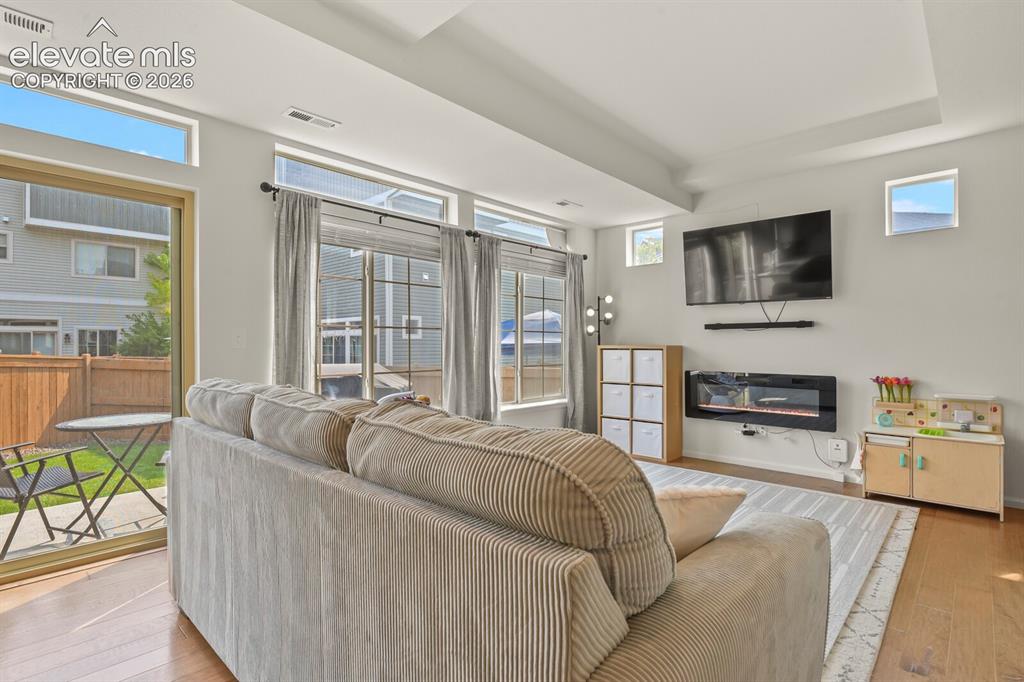 Image 7 of 31: Recessed ceiling with recessed lighting, wood flooring, multiple large wind