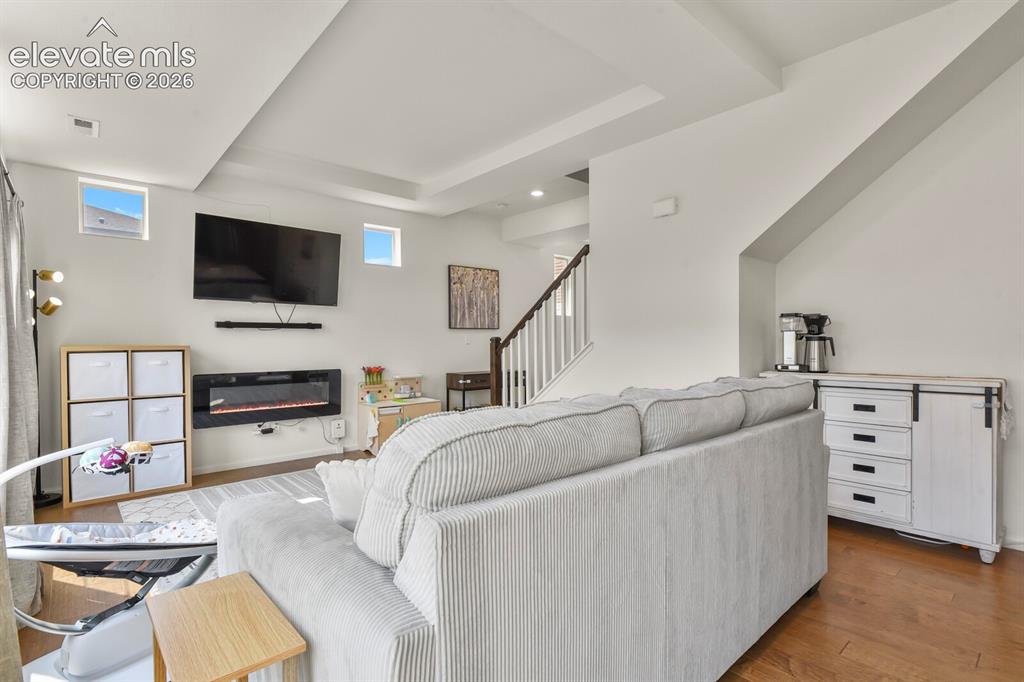 Image 8 of 31: Open-concept living area featuring wood flooring 