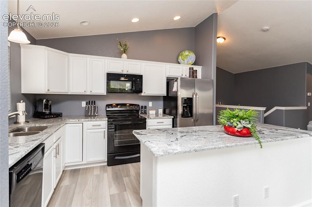 Image 11 of 49: Kitchen has ben remodeled with new cabinets and plumbing fixtures.