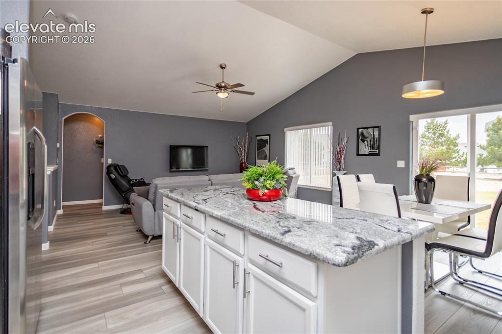 Image 12 of 49: Spacious kitchen island offers extra cabinet and counter space.