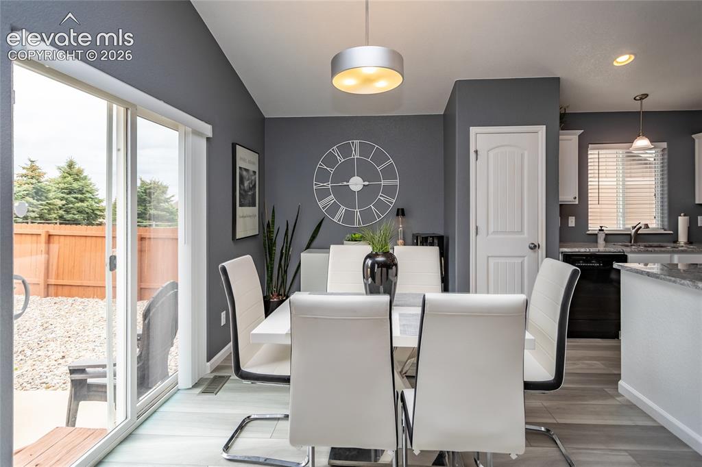 Image 13 of 49: Dining room walks out to the back patio and the spacious back yard.