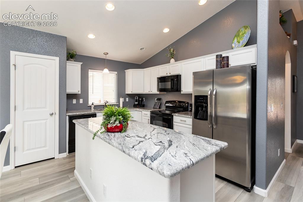 Image 15 of 49: Remodeled kitchen offers plenty of cabinet and counter space as well as a p