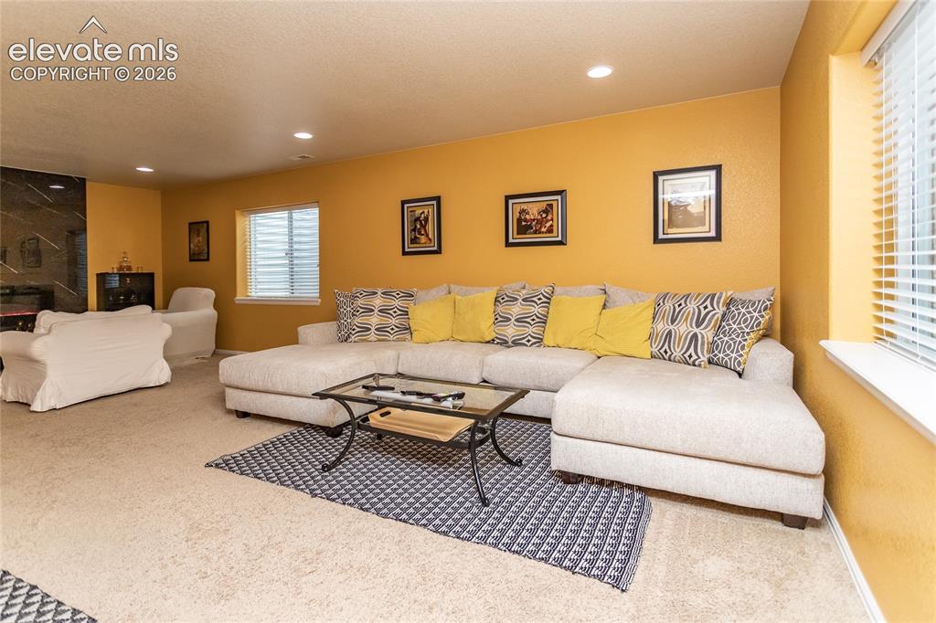 Image 31 of 49: Basement offers a huge rec room with sitting and entertainment areas.