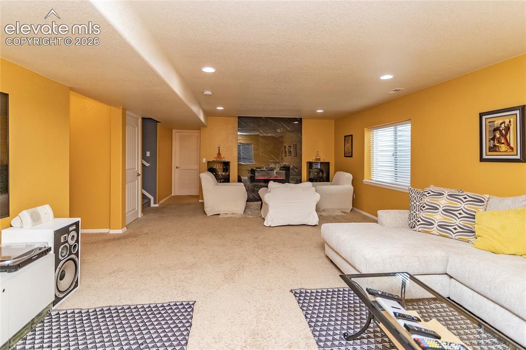 Image 32 of 49: Rec room with newer electric fireplace is entertainers dream! ( the paint c