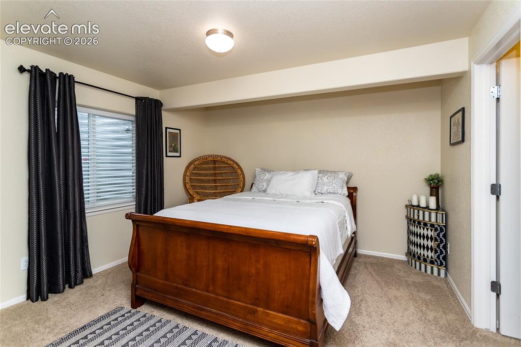 Image 35 of 49: Bedroom 3 in the basement is very roomy and has a huge walk-in closet.
