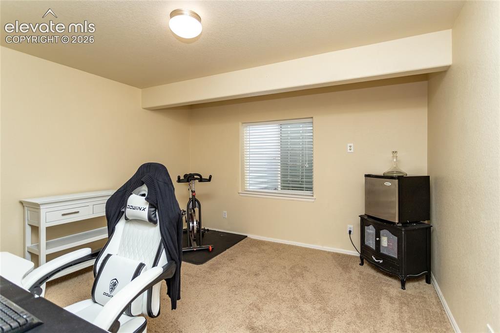 Image 38 of 49: Bedroom 4 in the basement is currently used as an office.