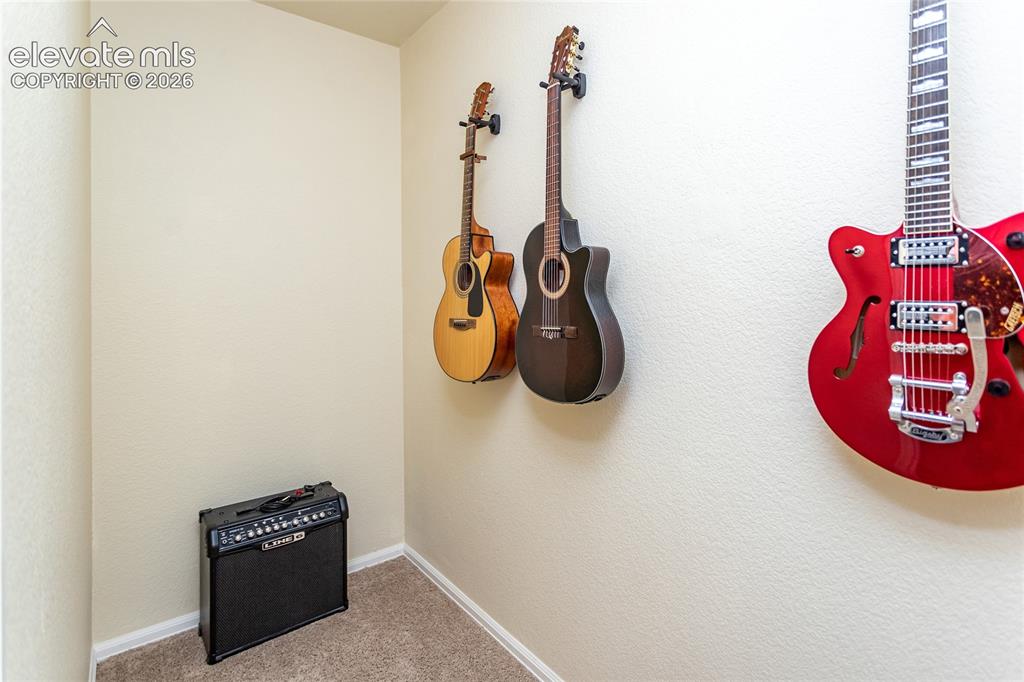 Image 40 of 49: Walk-in closet in bedroom 4 is currently holding guitars:)