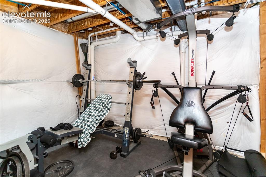 Image 41 of 49: Part of the mechanical room is being used as a home gym.