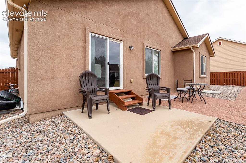 Image 44 of 49: Back of the home and patio.