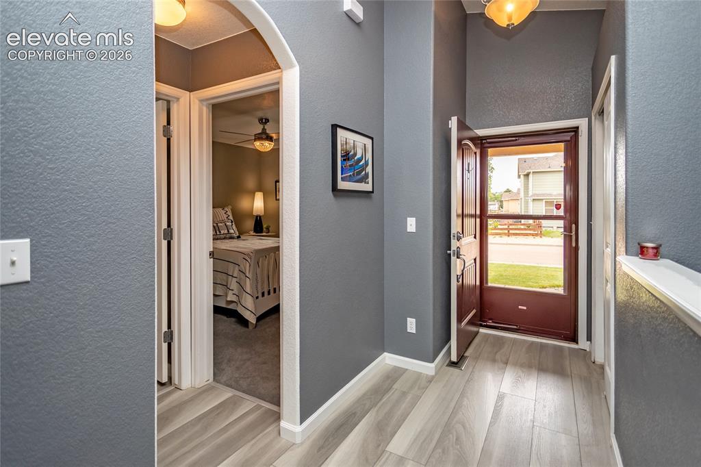 Image 6 of 49: Beautiful foyer opens up the the specious living areas with vaulted ceiling