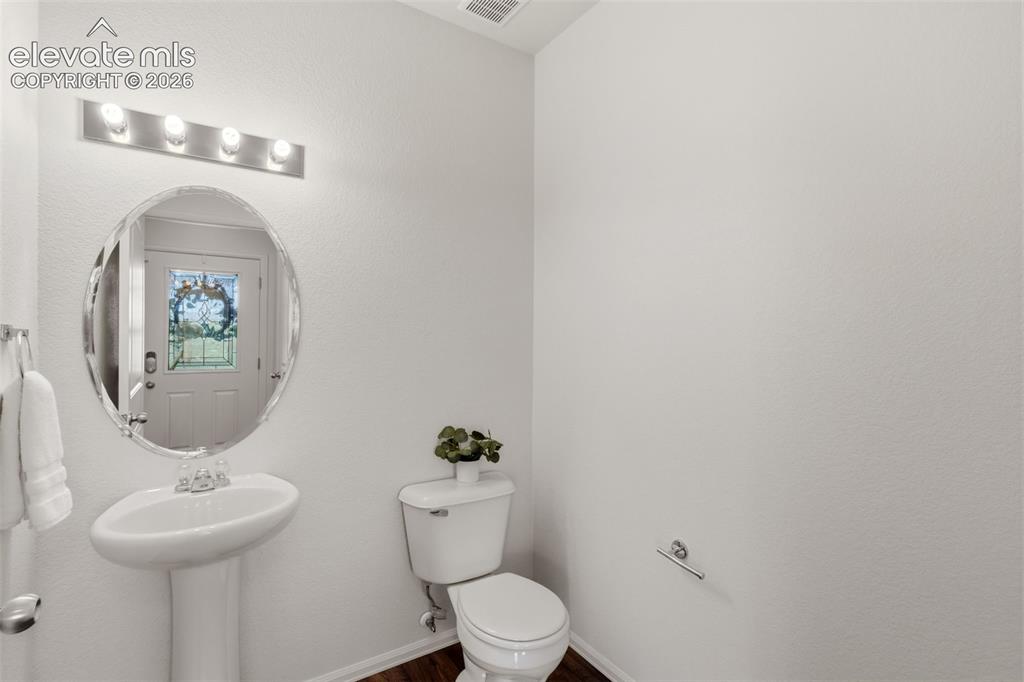 Image 16 of 38: A convenient main-level half bathroom offers excellent functionality for yo