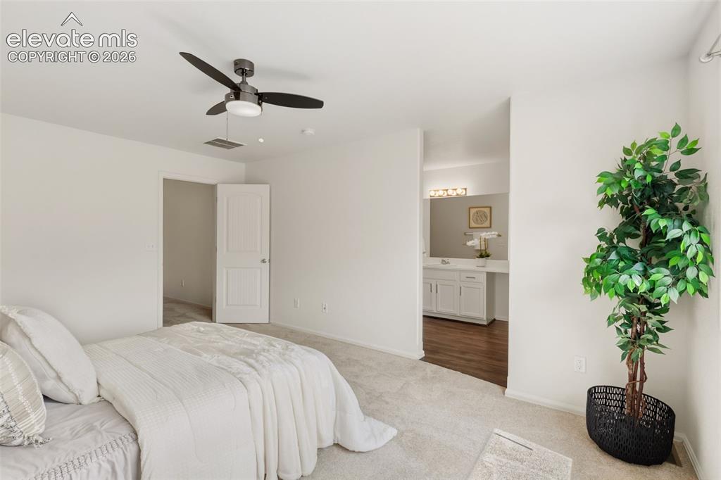 Image 18 of 38: Retreat to your private primary suite, complete with an adjoining full bath