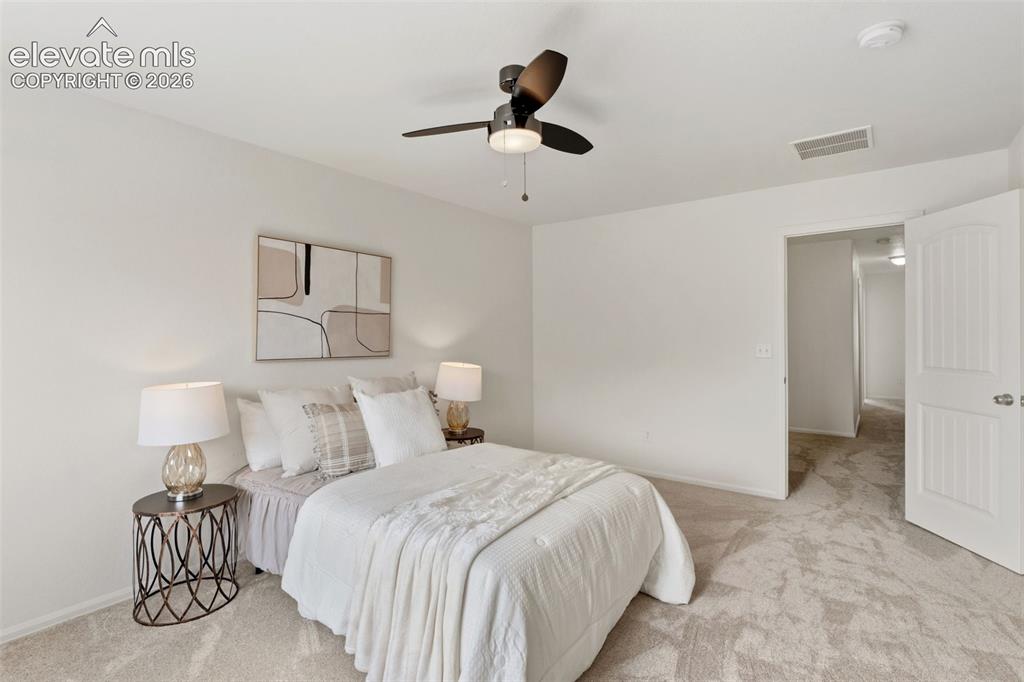 Image 22 of 38: With plenty of room for large furniture, this primary bedroom is the perfe