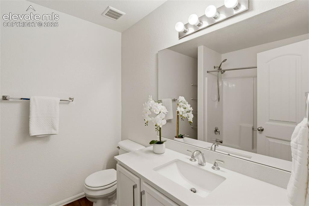 Image 26 of 38: The upper-level secondary bathroom boasts clean finishes and plenty of coun