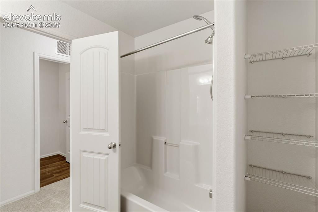 Image 27 of 38: A second upper-level full bathroom ensures flexibility and convenience for