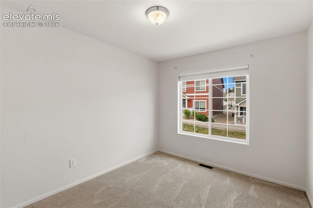 Image 28 of 38: This bright second bedroom is a flexible space just waiting to become a coz